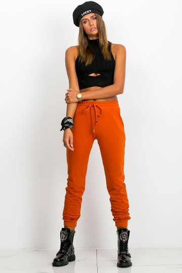Tumši oranžas bikses Ātrāk