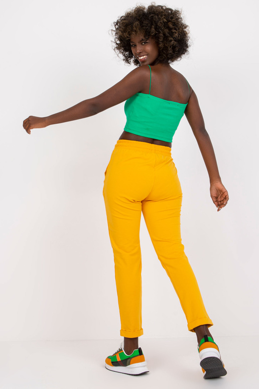 Pamata gaiši oranžas sporta bikses ar...