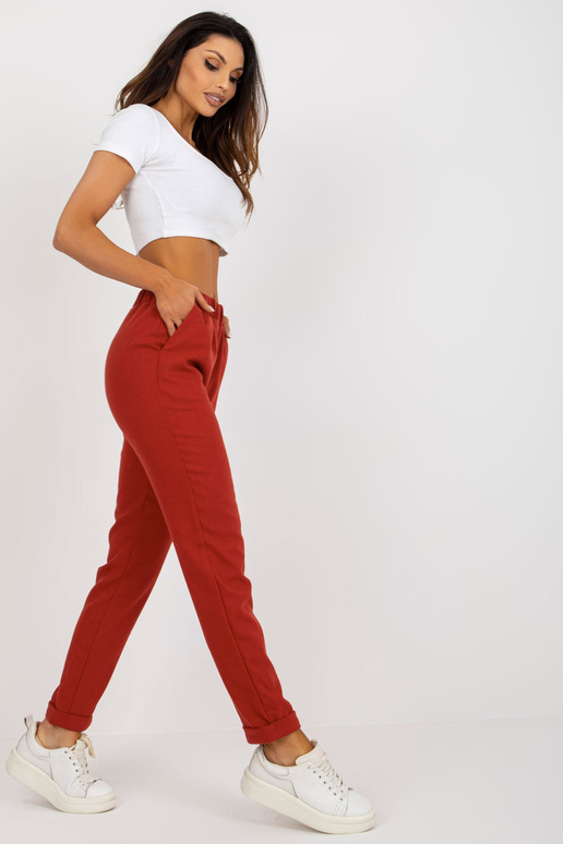 Tumši oranžas auduma bikses ar kabatām